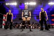 Adam Cole with The Bucks